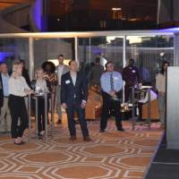 Alumni at the Chicago Alumni Reception listening to T.Haas and Marcia